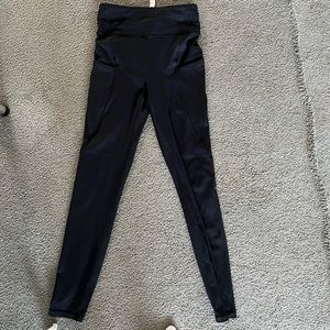 Black Lululemon leggings with side pockets and back zipper.